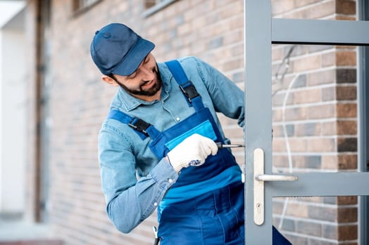 Workman installing locking mechanism for a door handle