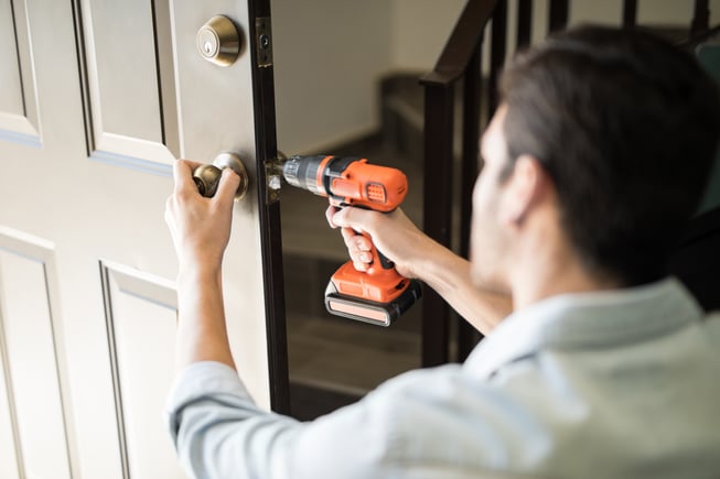 Man installing door knob 