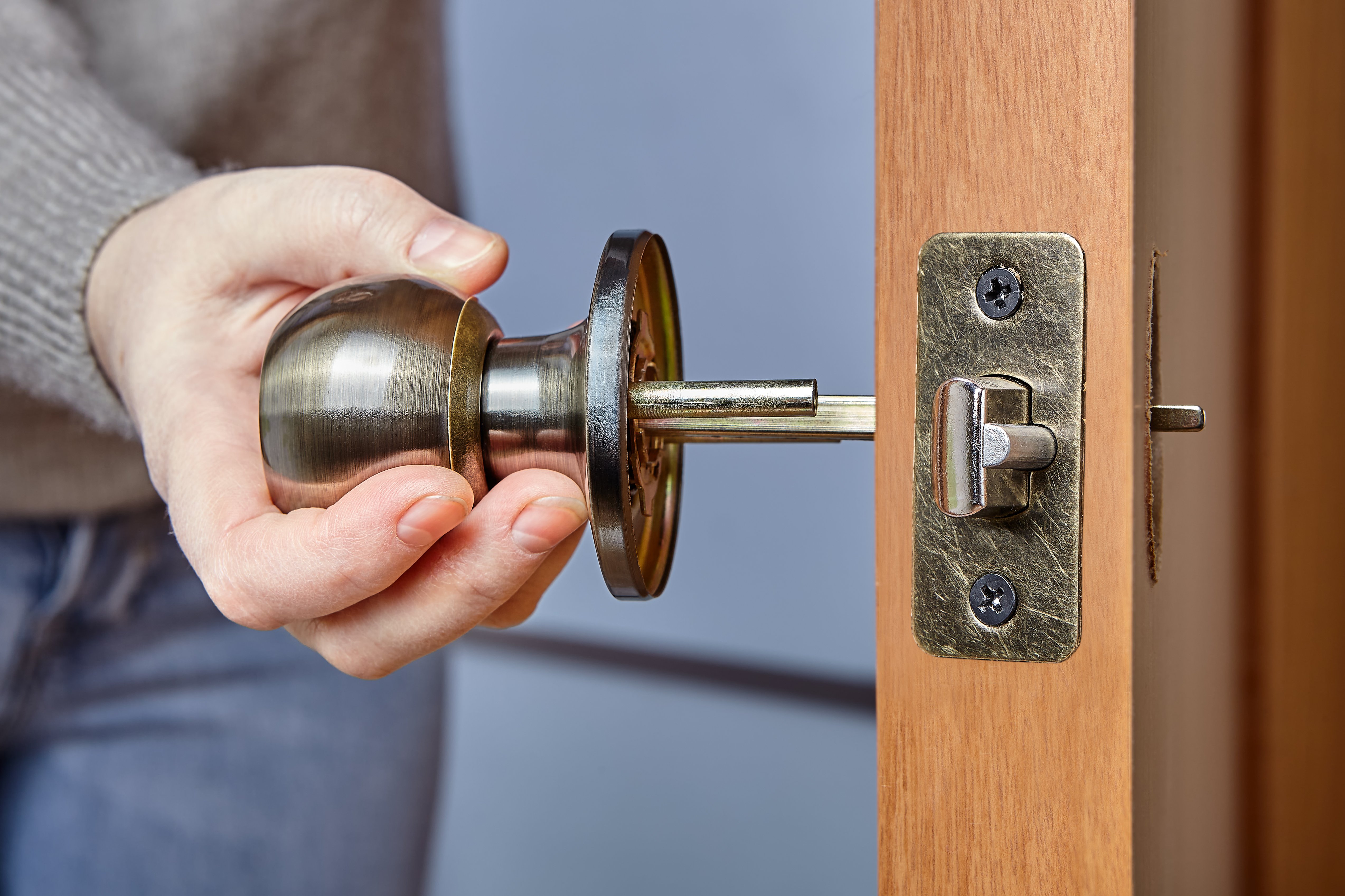 Man installing door knob on a door