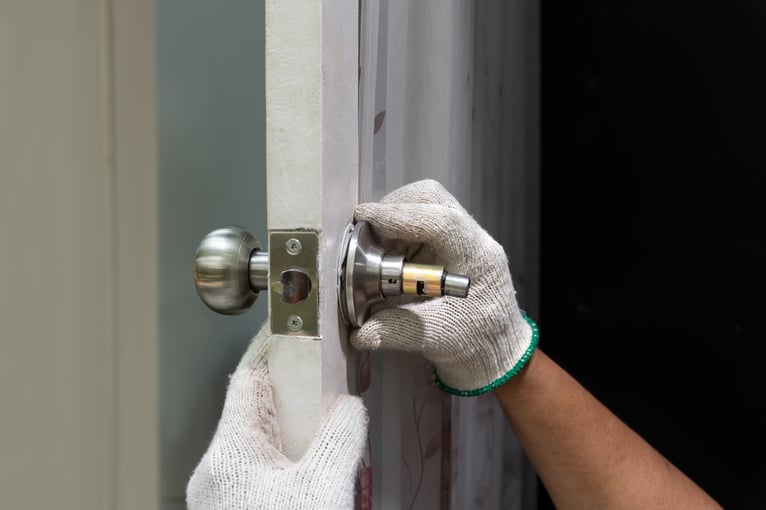 Work person fixing a doorknob